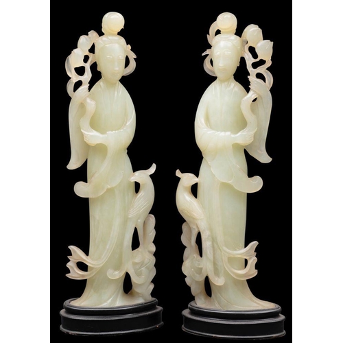 586 - A pair of Chinese carved hardstone figures of female Immortals each holding a peach spray, 20th cent... 