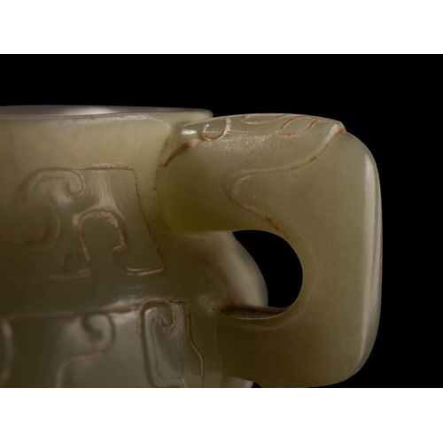 588 - A small Chinese jade censer in archaic style of bombe form with mythical beast handles, carved with ... 