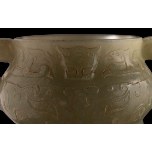 588 - A small Chinese jade censer in archaic style of bombe form with mythical beast handles, carved with ... 