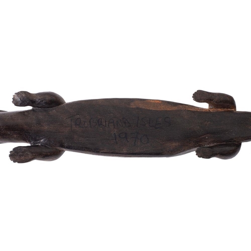 606 - A Trobriand Isles carved wooden crocodile inset shell eyes, 59cm long, dated to underside '1970'.