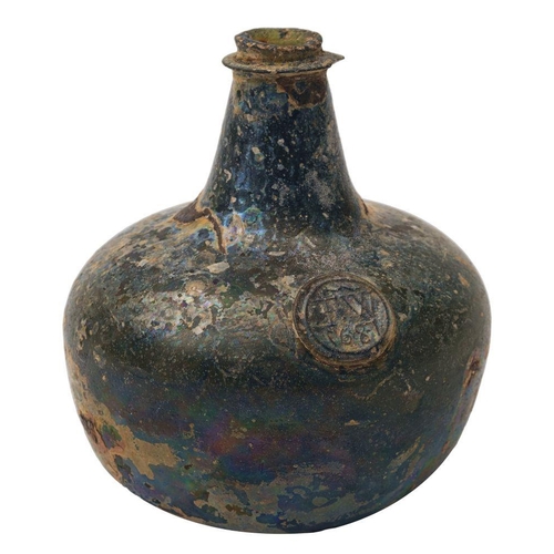 7 - A sealed transitional onion wine bottle dated 1687, of dark olive colour and of squat form with shor... 