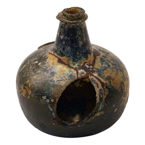 7 - A sealed transitional onion wine bottle dated 1687, of dark olive colour and of squat form with shor... 