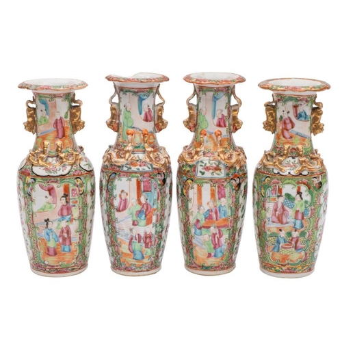 83 - A pair of Canton baluster vases and a similar pair both with applied gilt lion dog handles and chilo... 