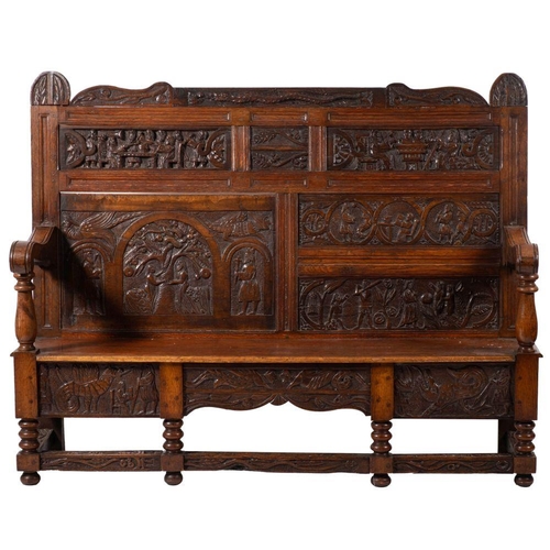 987 - An oak hall settle, elements 17th century and later constructed; the back rest and seat front incorp... 