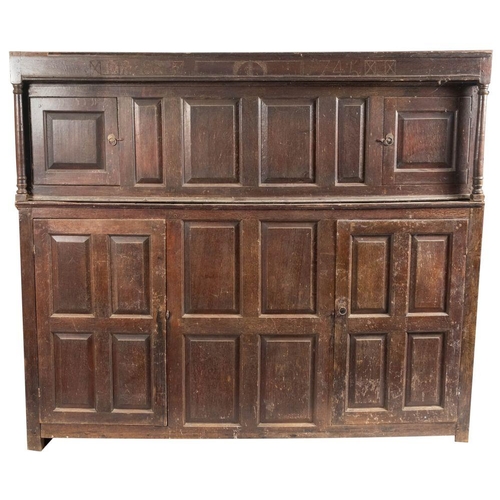 990 - A George II oak double fronted court cupboard, dated 1745; one front of the upper section with punch... 