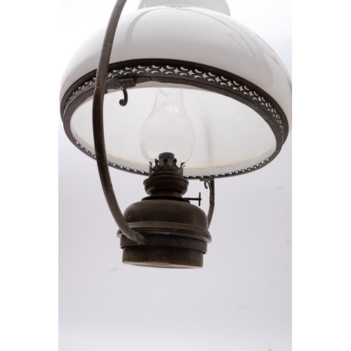 161 - A brass ship's hanging oil lamp: the inverted baluster frame  with white glass shade over copper bur... 