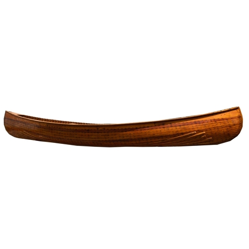 396 - An early 20th century Canadian cedar strip canoe: of traditional construction with three seats, one ... 