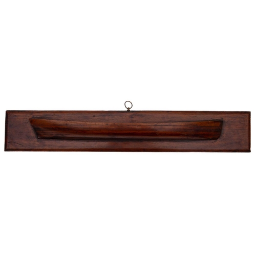 405 - A 19th century mahogany half block model of a skiff: the hull constructed in seven layers on a recta... 