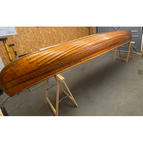 396 - An early 20th century Canadian cedar strip canoe: of traditional construction with three seats, one ... 