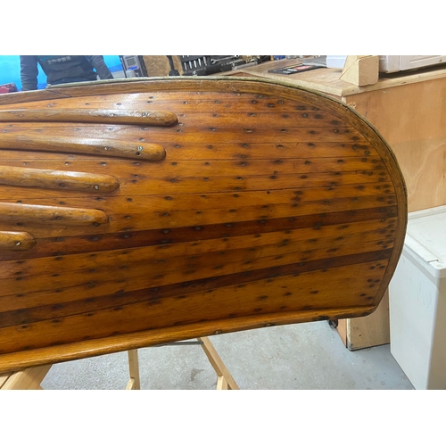 396 - An early 20th century Canadian cedar strip canoe: of traditional construction with three seats, one ... 