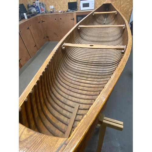 396 - An early 20th century Canadian cedar strip canoe: of traditional construction with three seats, one ... 