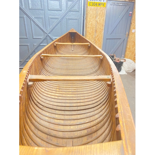 396 - An early 20th century Canadian cedar strip canoe: of traditional construction with three seats, one ... 