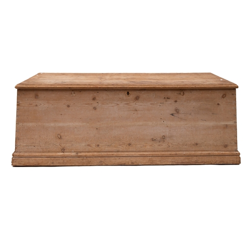 153 - A large pine trunk: fitted iron drop handles to either side, 56 x 159 x 68cm.