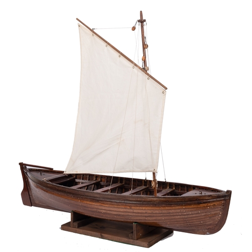 413 - A scale model of a gaff rigged jolly boat:  set sails over plank and pinned hull with fixtures and f... 