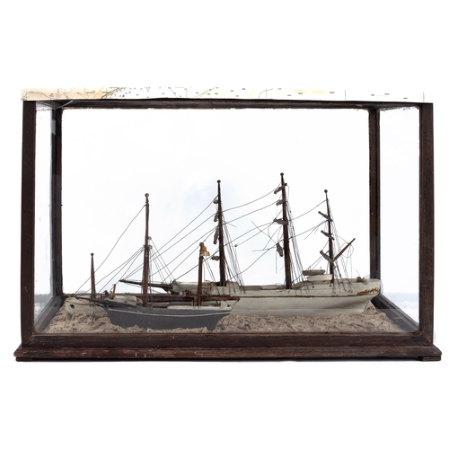 420 - A late 19th century cased diorama of sailing vessels:  comprising a white hulled three masted ship, ... 