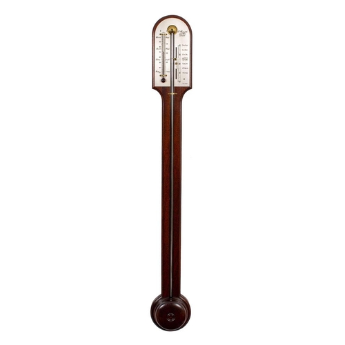 511 - Comitti, London a reproduction stick barometer the mahogany curved-top case having a turned cistern ... 