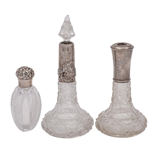 2022 - Three clear glass and silver mounted scent bottles, various makers and dates, one stopper missing.