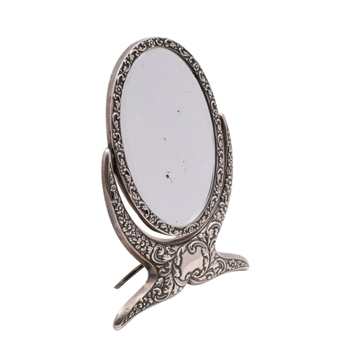 2116 - An Edward VII silver oval swing frame easel dressing table mirror, Chester 1902 with embossed flower... 