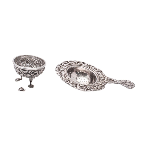 2182 - A white metal tea strainer, probably Indian, unmarked, 42grams, 13cm long, together with a silver pl... 