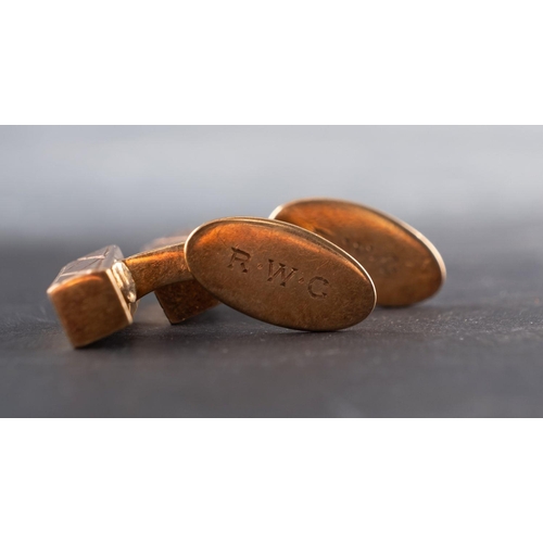 2538 - A pair of bar-shaped cufflinks, engraved with cross-hatch pattern, stamped '18K', length of cufflink... 