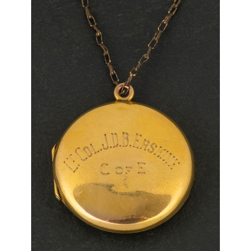 2723 - An early 20th century circular locket pendant, stamped  '9CT BACK & FRONT', with inscription to fron... 