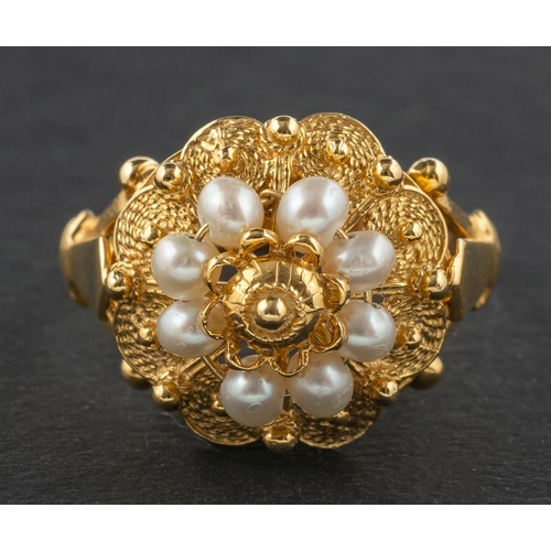 2730 - A seed pearl and cannetille ring, of flowerhead design, stamped '585', length of ring head ca. 1.7cm... 