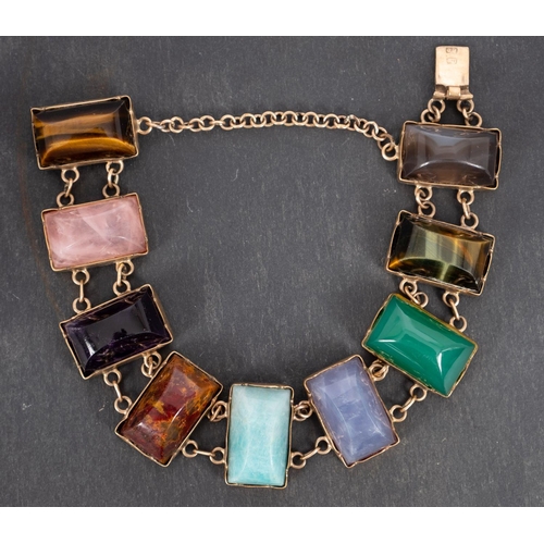 2739 - A cabochon-cut, vari-coloured gemset bracelet, including inter alia  tiger's eye, rose quartz, chrys... 