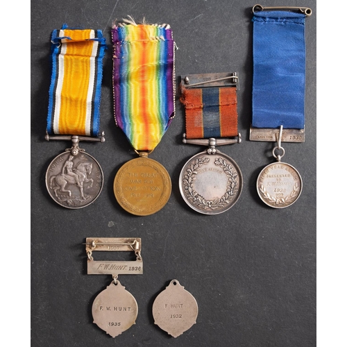 293 - A WWI group of three to 'M-338425 Pte F.W. Hunt ASC,' War Medal, Victory Medal, and silver National ... 