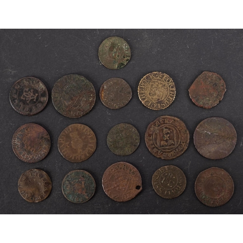 74 - Approximately sixteen 17th Century farthings and half penny tokens.