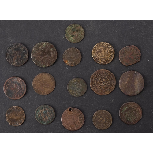 74 - Approximately sixteen 17th Century farthings and half penny tokens.