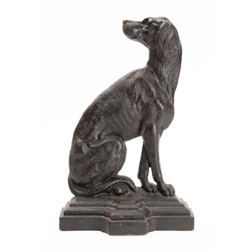 535 - A Victorian cast iron doorstop in the form of a seated  dog in a stepped base, with registration loz... 