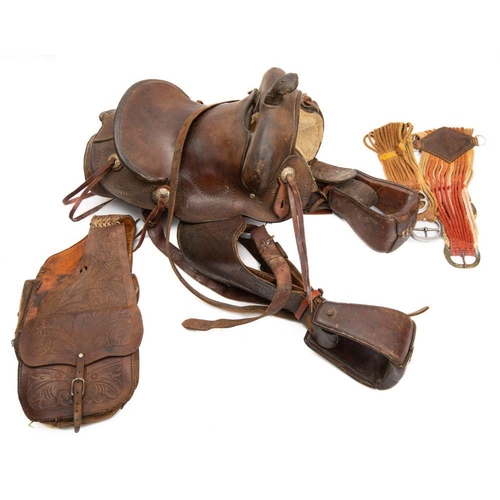 553 - A New Mexico  brown leather roping saddle, of traditional form with embossed floral decoration.
