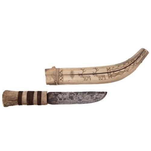 696 - An early 20th century Inuit  reindeer bone and steel knife, the  straight single edge blade  over a ... 