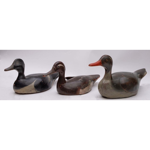 563 - Three painted wooden decoy ducks, probably early 20th century, largest 41cm. (3)