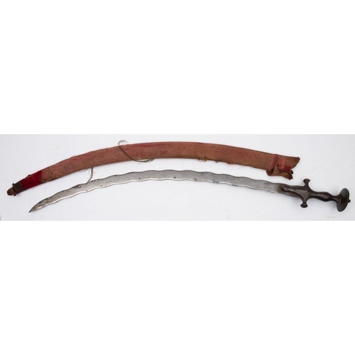 686 - A 19th-century Indian Tulwar, the curved waved single-edged blade over traditional form iron hilt wi... 