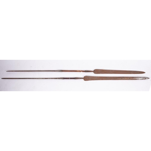 690 - Two early 20th century African? spears, both with elongated  ridged leaf shaped blade and  spiked fo... 