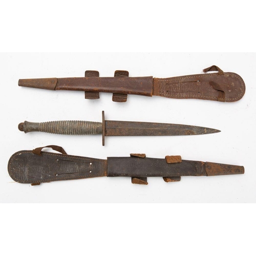 692 - A Fairbairn Sykes fighting knife, the straight double edge blade over an oval hilt and cast one piec... 