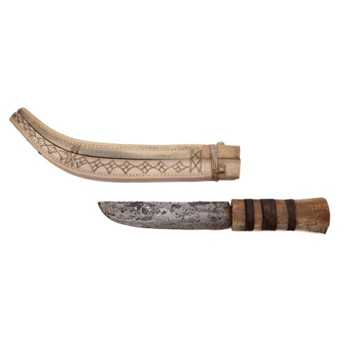 696 - An early 20th century Inuit  reindeer bone and steel knife, the  straight single edge blade  over a ... 