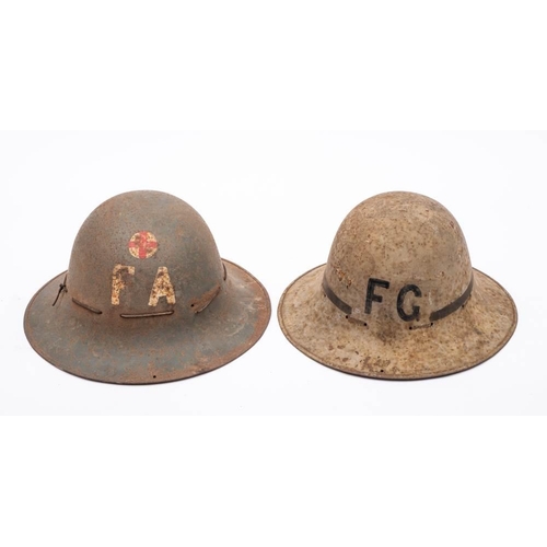 774 - Two WWII period Zukerman steel civil defence helmets, one a Fire Guard helmet, the other First Aid  ... 