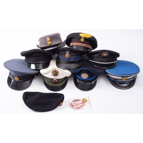 824 - A group of various Foreign Police peaked caps, including a German Motorway Patrol cap, South African... 