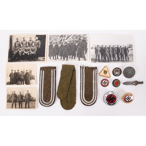 833 - A small collection of German Militaria, including and NSDAP badge, epaulettes and four WWII photogra... 