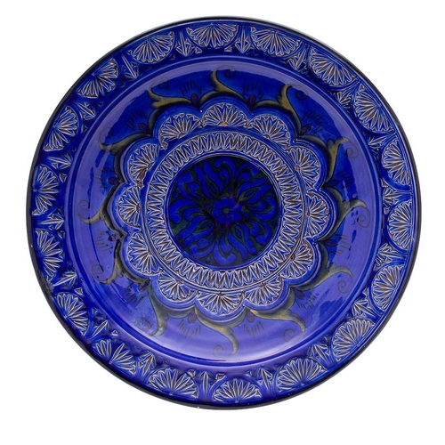 130 - A French pottery bowl, of circular form the centre and rim with incised florets with painted green a... 