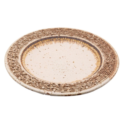 131 - A grogged stoneware charger, with deeply textured border under ivory glazes and a flown russet band,... 