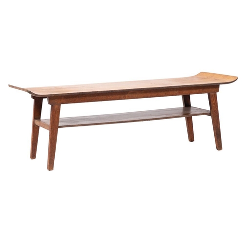 430 - An oak and oak laminate coffee table, circa 1960s; with upcurved ends above an undershelf, with spla... 