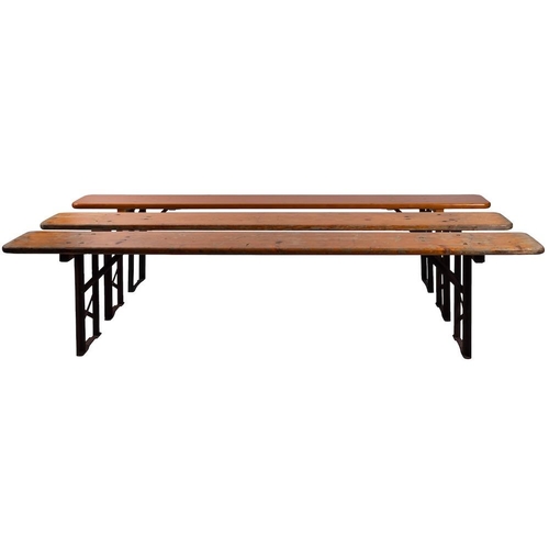 431 - Two German pine and metal folding tables, with three similar benches en suite, 20th century; the tab... 