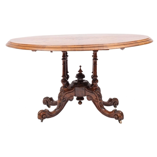 1054 - A Victorian walnut and inlaid oval breakfast or Loo table; the quarter veneered snap top with a cent... 