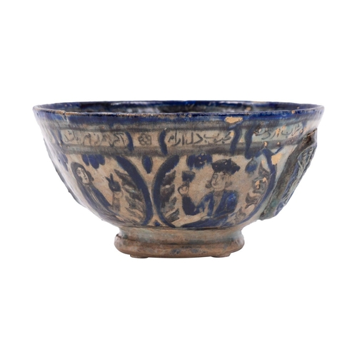 106 - A Persian pottery bowl decorated in blue and grey with bands and panels of portraits, inscriptions a... 