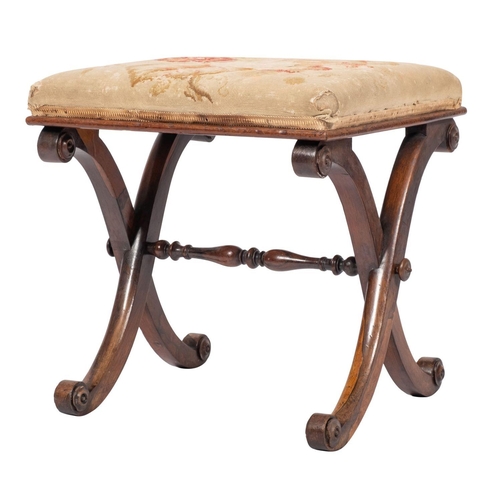 1104 - An early Victorian X-frame rosewood stool; the rectangular pad top with cabbage rose embroidery, uni... 