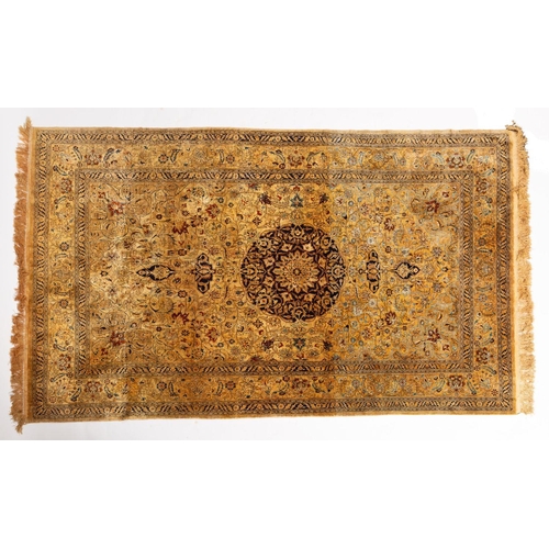 1177 - A Kashmir silk rug, the light brown field with a central circular indigo pole medallion, all over pa... 