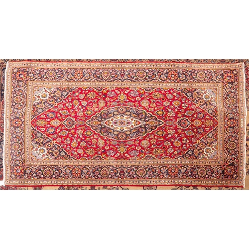 1193 - A Shadsar signed Kashan rug, the shaded wine cartouche field with a cartouche pendant medallion, all... 